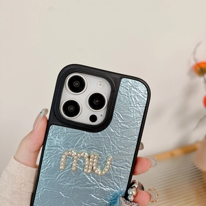 Close-up of sky blue leather iPhone case with crystal Miu logo and wrinkled texture
