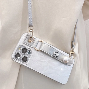 Detail of floral pearl strap iPhone case with mica texture and crossbody leather strap