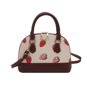 Chic strawberry print shell handbag with cream leather body and dark brown handles