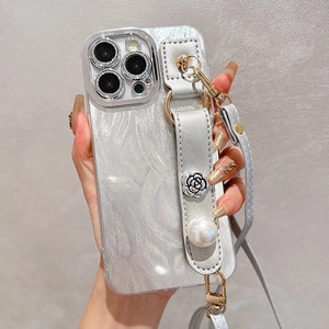 Detail of silver iridescent floral phone case with pearl wrist strap and crossbody strap