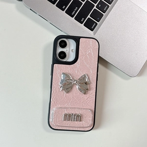 Detail of pink crinkled leather phone case with silver metal bow and MIU emblem decoration