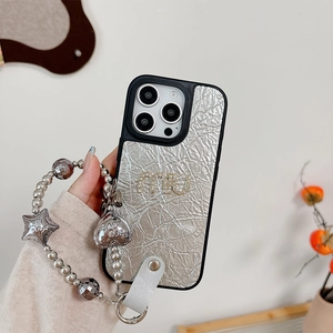 Detail of silver crinkle leather iPhone case with rhinestone logo and star charm strap