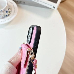 Detail of pink snakeskin texture phone case with card holder and lanyard for iPhone