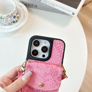 Detailed close-up of pink snakeskin pattern iPhone case with leather card slot and strap