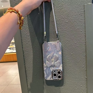 Detail of silver bow iPhone case with pearlescent texture and crossbody strap