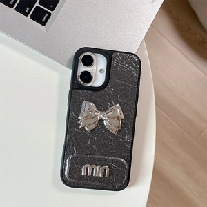Close-up of black leather iPhone case with silver metal bow and embossed letter details