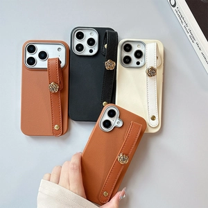 Lychee texture leather phone case with camellia metal wristband for iPhone 16 Pro Max