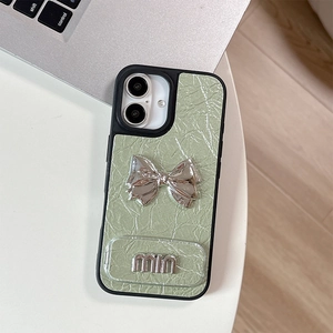 Detail of mint green leather phone case with silver metal bow and 3D min lettering