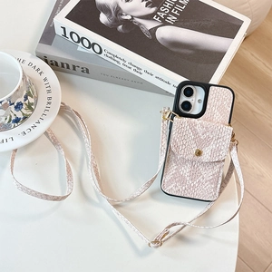 Chic snakeskin textured iPhone case featuring a pink crossbody strap and built-in wallet