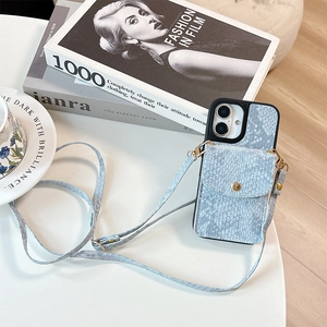 Detail view of light blue snakeskin phone case with card slot and crossbody strap