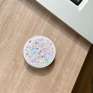 Detail of round phone socket holder with iridescent glitter and purple star sequins