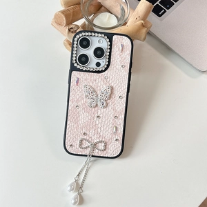 Detail of pink iPhone case with rhinestone butterfly and elegant pearl tassels