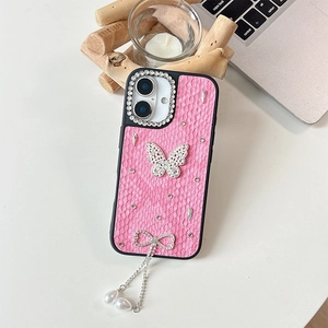 Detail of pink crocodile leather iPhone case with rhinestone butterfly and pearl charms