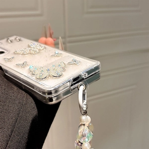 Detail of glitter phone case with 3D crystal butterflies and white pearl wrist strap