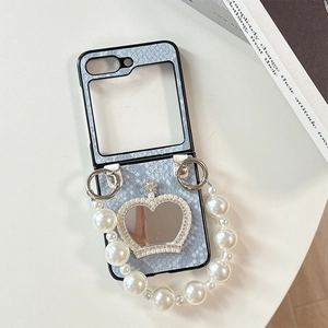 Detail of blue snake texture phone case for Samsung Z Flip with crown mirror and pearl chain