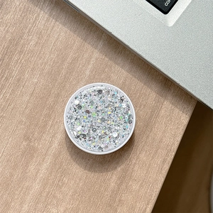 Macro shot of round silver glitter phone socket grip with sparkling holographic sequins
