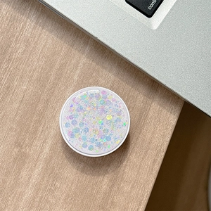 Macro shot of circular phone socket with iridescent glitter sequins on wooden table