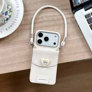 Détail d'une coque en cuir blanc avec cœur en strass et bandoulière amovible