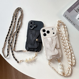 Detail of luxury phone case with pearl-decorated crossbody chain and card holder