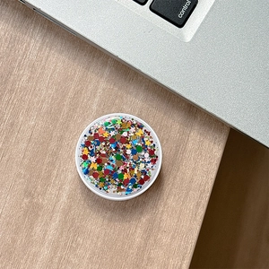 Macro detail of round phone socket holder with glitter and star shaped sequins