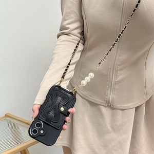 Crossbody iPhone case with black leather bow card holder and pearl chain strap