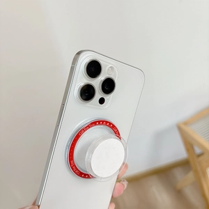 Macro shot of red MagSafe magnetic ring with Gift For You print and white air bag holder