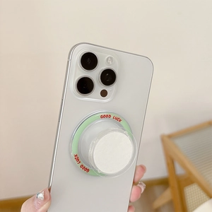 White magnetic cell phone grip with Good Luck text mounted on a smartphone