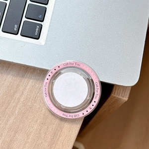 Detailed macro view of a pink circular MagSafe phone stand with Gift For You engraving