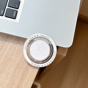 Detail of round MagSafe magnetic phone socket with Gift For You print on a laptop