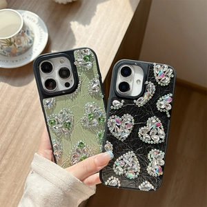 Luxury iPhone case with leather texture, large heart-shaped crystals, and butterfly patterns