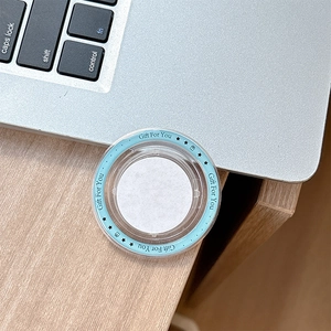 Detail of round transparent gift box lid with light blue Gift For You decorative border