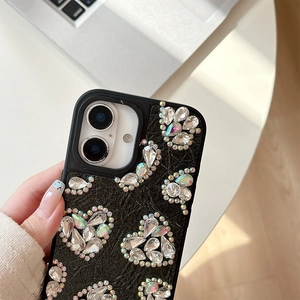 Detail of luxury heart-shaped rhinestones on black leather phone case for iPhone