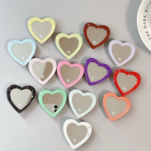 Glitter heart-shaped phone grip mirrors in multiple colors with minimalist design