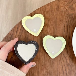 Glitter heart-shaped phone grip and makeup mirror in yellow, green, and black resin
