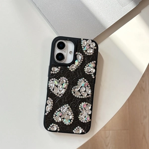 Detail of black leather texture phone case featuring colorful rhinestone heart patterns