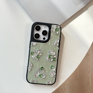 Close-up of heart-shaped rhinestones on mint green pleated leather iPhone case