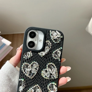Detail of luxury rhinestone heart and butterfly patterns on black iPhone case