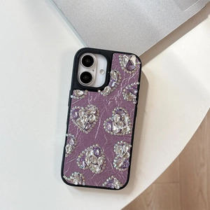 Detail of purple lychee leather phone case with sparkling crystal heart decorations