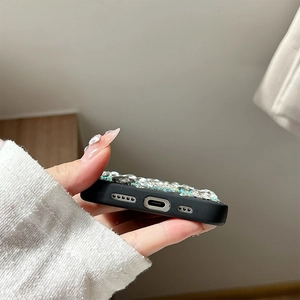 Detailed close-up of precise charging port cutouts on luxury rhinestone heart phone case
