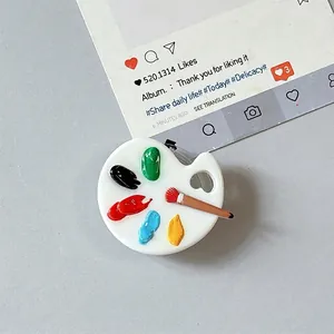 Artistic mini palette phone grip featuring colorful paint dots and a small brush detail