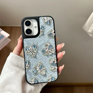 Detail of light blue iPhone case with lace texture and rhinestone heart decorations