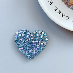 Macro view of blue glitter heart phone socket with sparkling sequins and holographic finish