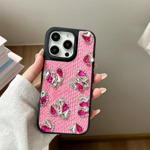 Detail of pink lace texture and rhinestone heart patterns on a protective iPhone case