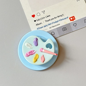 Artistic palette phone socket detail with colorful 3D paint dots and a pink brush