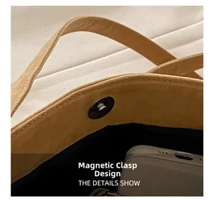 Close-up of magnetic snap closure on tan suede hobo bag with internal lining