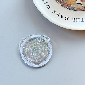 Macro view of heart-shaped glitter phone grip with iridescent sequins and acrylic finish