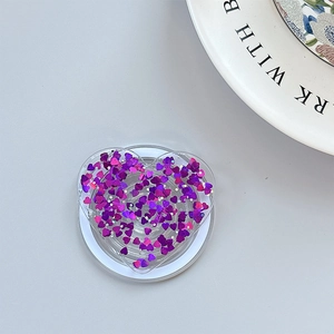 Macro detail of heart-shaped phone grip with sparkling purple and pink sequins decoration
