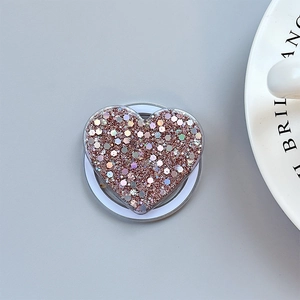 Detail shot of heart-shaped phone socket with rose gold sequins and glitter finish