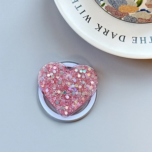 Macro shot of glittery heart phone socket with pink sequins and white base