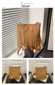 Detail of khaki tassel crossbody bag with soft suede texture and long fringe accents